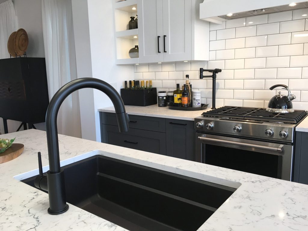 Modern black ceramic sink with white granite counter tops