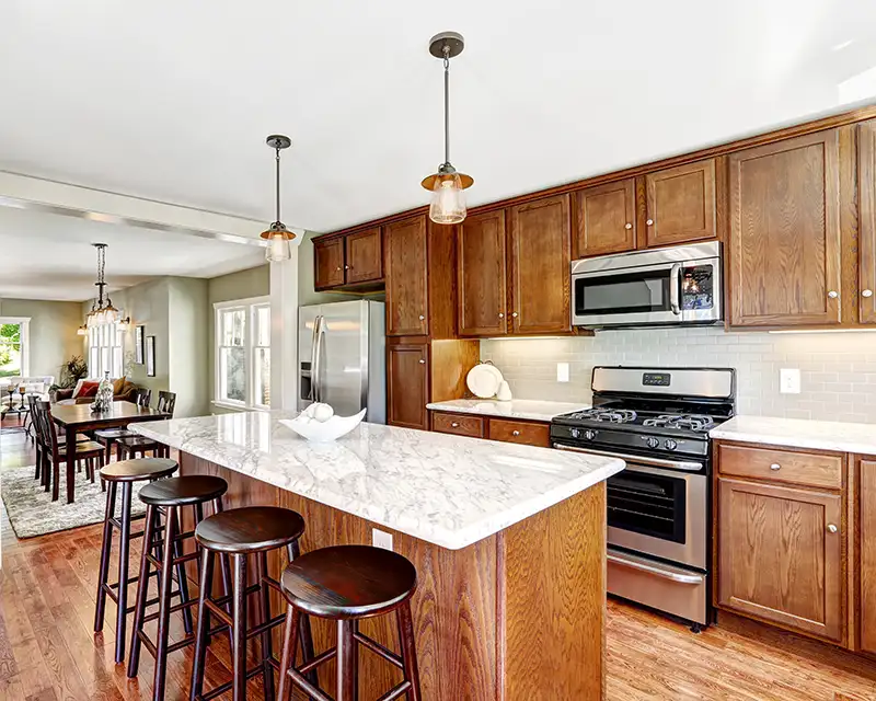 Marble countertops and wood cabinets in a kitchen remodel